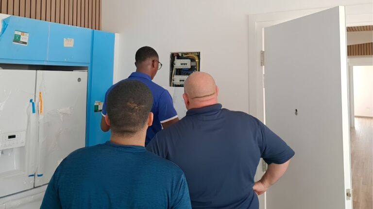 HVAC Aruba professional installation team working on electrical panel for commercial air conditioning system
