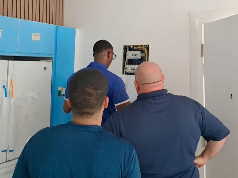 HVAC Aruba professional installation team working on electrical panel for commercial air conditioning system
